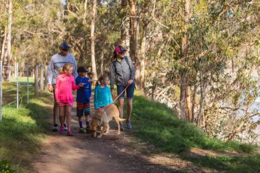 old San Simeon family walking dog on trail
